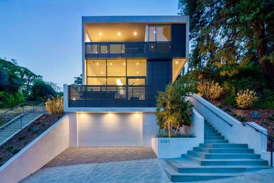 Trendy gray three-story flat roof photo in Los Angeles