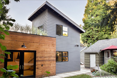 Small trendy gray two-story mixed siding exterior home photo in Portland with a shed roof