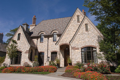 Example of a gray stone exterior home design in Milwaukee