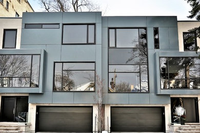 Mid-sized minimalist gray two-story metal exterior home photo in Toronto with a metal roof