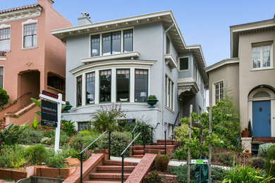 Large and blue traditional detached house in San Francisco with three floors.