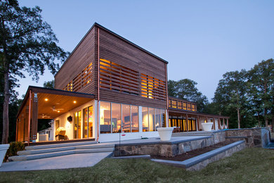 Example of a large minimalist beige two-story wood exterior home design in St Louis