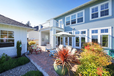 Inspiration for a coastal blue two-story mixed siding exterior home remodel in Seattle with a hip roof