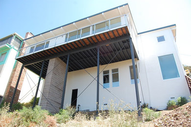 Example of a mid-sized minimalist white two-story mixed siding flat roof design in San Francisco