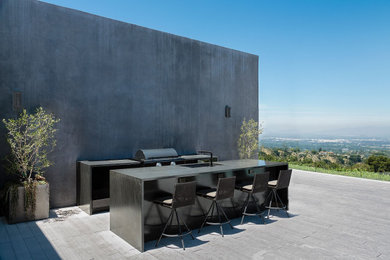Example of a large minimalist gray one-story stucco exterior home design in Los Angeles with a shingle roof