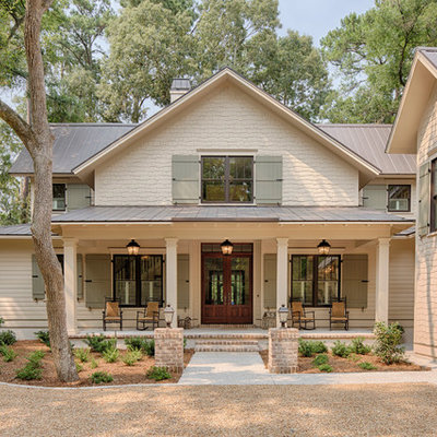 Example of a mid-sized cottage beige two-story wood gable roof design in Grand Rapids