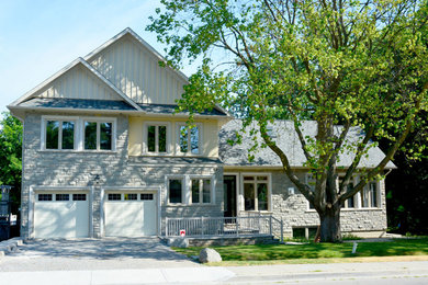 Photo of a medium sized modern two floor house exterior in Toronto with mixed cladding.