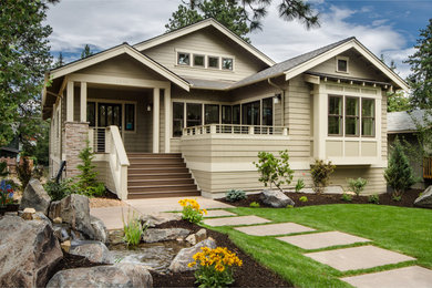 Example of an arts and crafts beige exterior home design in Seattle