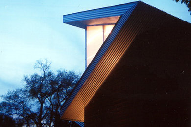 Example of a small minimalist brown two-story wood exterior home design in Nashville with a shed roof