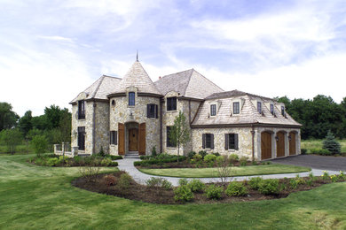 Mid-sized elegant two-story stone exterior home photo in Chicago