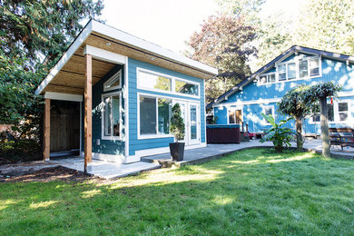 Mid-sized elegant blue one-story vinyl exterior home photo in Vancouver with a shed roof