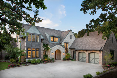 Inspiration for a mid-sized timeless multicolored two-story exterior home remodel in Dallas with a shingle roof