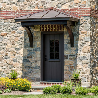 Inspiration for a large timeless brown two-story stone exterior home remodel in Wilmington with a shingle roof
