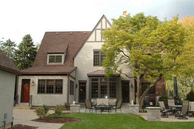 Large traditional gray three-story stucco gable roof idea in Chicago