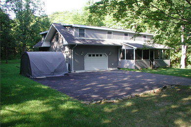 Mid-sized elegant gray two-story wood house exterior photo in New York with a hip roof and a shingle roof