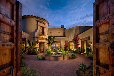 Example of a tuscan two-story exterior home design in Phoenix