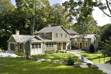 Mid-sized traditional beige two-story vinyl gable roof idea in New York