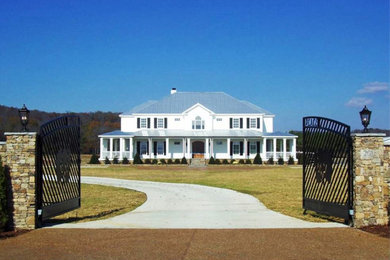 Example of a farmhouse white two-story exterior home design in Other with a hip roof