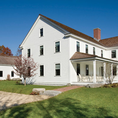 Large cottage white two-story wood exterior home photo in Boston