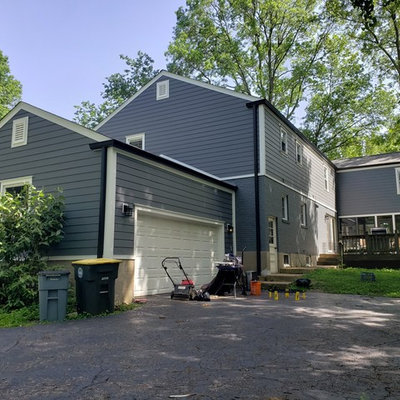 Example of a mid-sized classic gray two-story concrete fiberboard exterior home design in St Louis with a shingle roof
