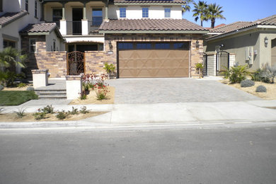 Large elegant beige two-story mixed siding exterior home photo in Los Angeles with a tile roof