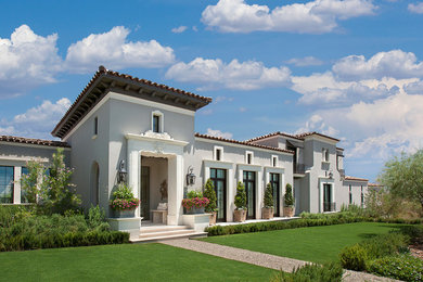 Large mediterranean beige two-story stucco exterior home idea in Phoenix with a tile roof
