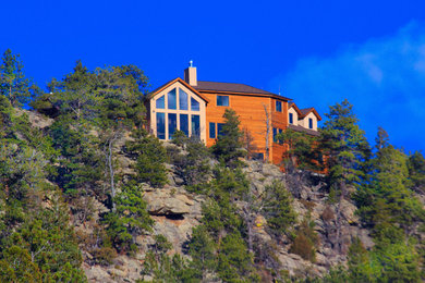 Example of a large mountain style multicolored two-story mixed siding exterior home design in Denver with a shingle roof