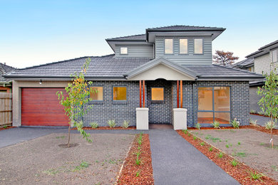 Trendy brick exterior home photo in Melbourne