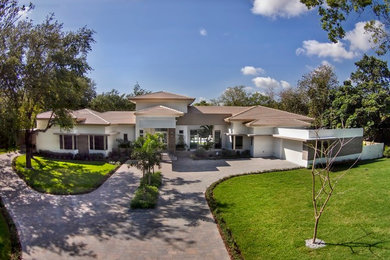 Photo of a large and white modern bungalow render house exterior in Miami.