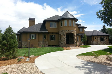 Inspiration for a timeless beige two-story stucco house exterior remodel in Denver