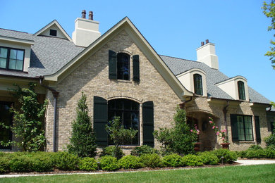 Example of a large classic two-story brick exterior home design in Other