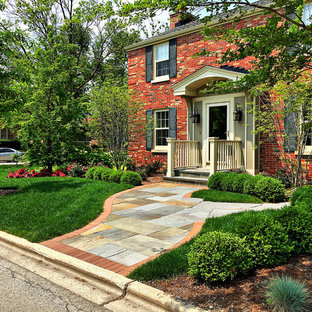 Inspiration for a small timeless red two-story brick exterior home remodel in Chicago