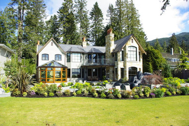 Example of a large trendy beige two-story stone exterior home design in Vancouver