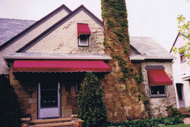 Example of a mid-sized one-story stone exterior home design in Minneapolis