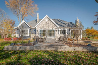 Mid-sized transitional gray one-story stone exterior home idea in Detroit with a shingle roof