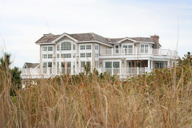 Example of a huge beach style beige three-story wood exterior home design in Philadelphia
