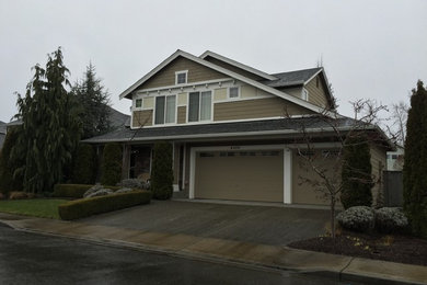 Large elegant brown two-story concrete fiberboard exterior home photo in Seattle