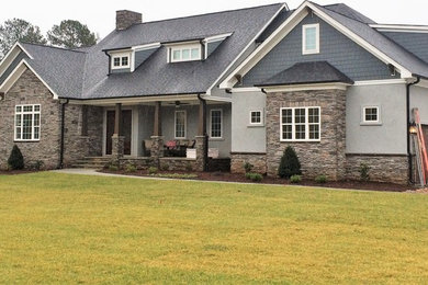 Example of a large trendy gray two-story exterior home design in Charlotte