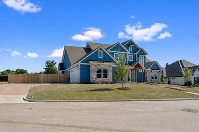 Example of a large classic blue two-story concrete fiberboard exterior home design in Austin with a shingle roof