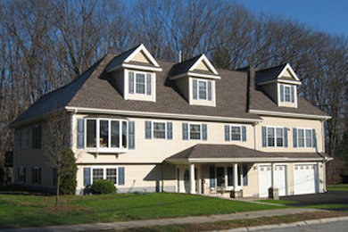Large beige three-story vinyl exterior home photo in Boston
