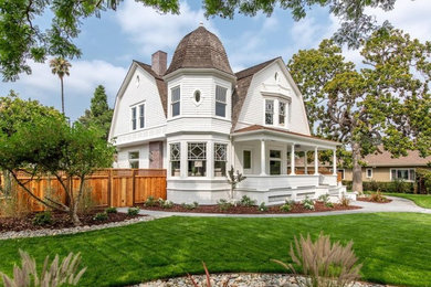 Example of a minimalist white two-story wood house exterior design in San Francisco with a shingle roof