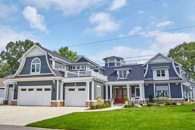 Inspiration for a mid-sized timeless blue two-story mixed siding exterior home remodel in Other with a gambrel roof