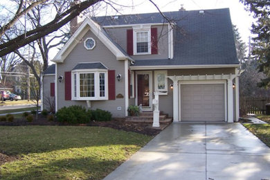 Design ideas for a gey classic two floor house exterior in Chicago with vinyl cladding.