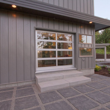 Exterior detail of living room, operable "fire station garage door" for patio