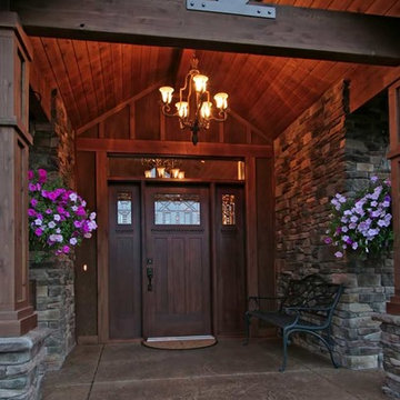 Exterior entry-way with chandelier lighting and set back door