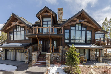 Inspiration for a large rustic brown three-story wood exterior home remodel in Denver