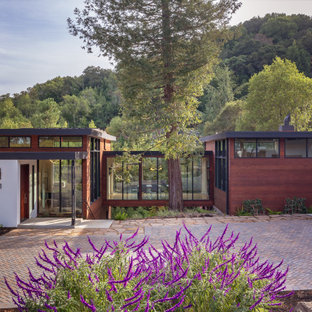 Design ideas for a large midcentury split-level multi-coloured house exterior in San Francisco with mixed siding and a flat roof.