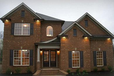 Craftsman red two-story brick exterior home idea in Nashville