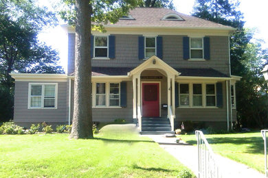 This is an example of a gey classic two floor house exterior in New York with wood cladding.