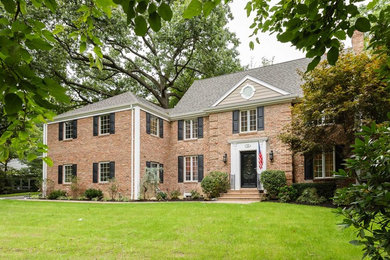 Example of a mid-sized classic three-story brick exterior home design in New York
